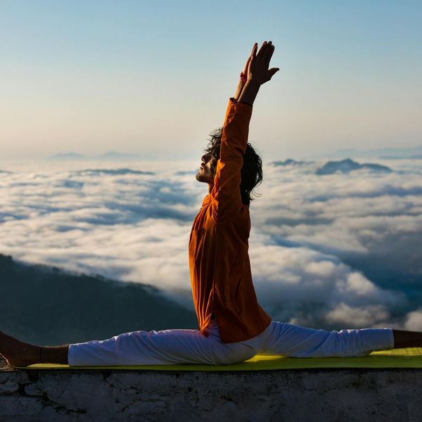 Man stretching outdoors during sunrise, showing flexibility and calm.